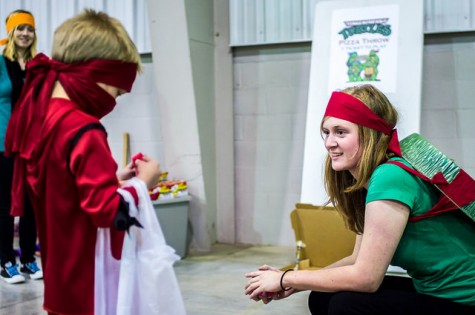 SGA member and Ninja Turtle Rachel Frederick helps a Red Ninja Avenger with his candy