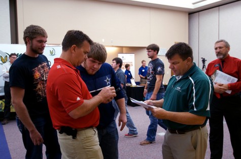 Dr. Burton Pflueger (right) looks on as Ag Coop professionals talk to Northeast Ag students