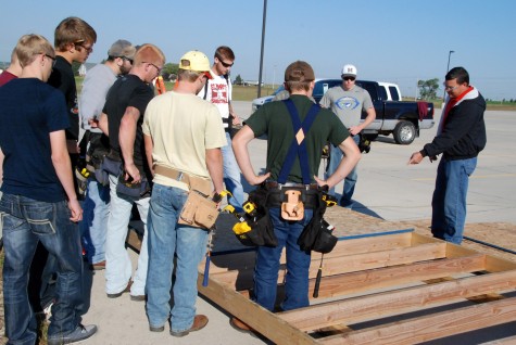 Pulling together for Pilger Ryan Hobza, building construction instructor at Northeast Community College, instructs members of his freshman class as they construct a shed at First Christian Church in Norfolk. The church accepted the help from the students to construct two of the sheds, which will be sent to Pilger along with several others. First Christian is providing the sheds to victims of a June 16 tornado who plan to rebuild their homes in the Stanton County village. (Courtesy Northeast Community College)
