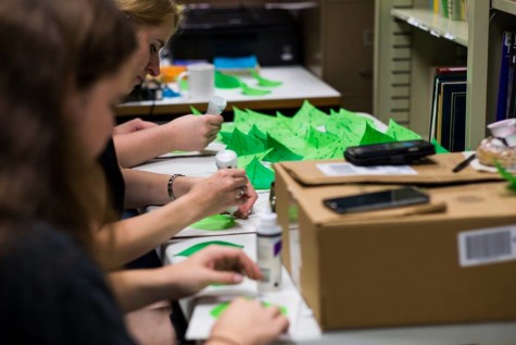 Northeast theatre staff making leaves with tissue paper, wire, and twigs