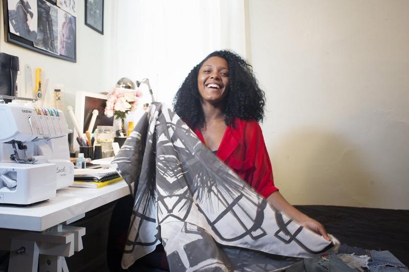 Moore College of Art graduate Dom Streater, winner of the 12th season of Lifetimes Project Runway, poses for portrait with a fabric sample from a current project at home in the Overbrook section of Philadelphia, October 20, 2013. (Ed Hille/Philadelphia Inquirer/MCT)