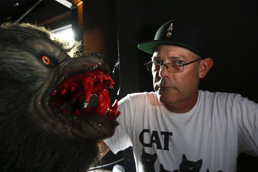 John Murdy, executive producer of Halloween Horror Nights at Universal Studios Hollywood, with one of many werewolves during a tour of the mazes that are being set up around the theme of the horror movie An American Werewolf in London in Universal City, Calif.