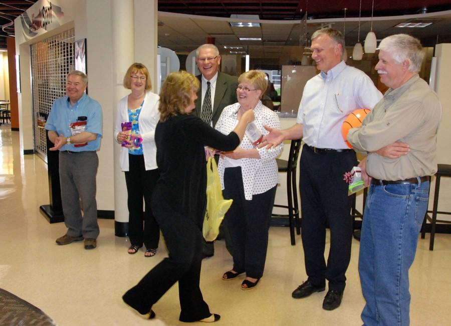 Corinne Morris, dean of math, agriculture, and science at Northeast Community College, hands out trail mix to six retirees during a recent reception wishing them “happy trails” on the road ahead. Pictured (from left) are John Miller, Shirley Powers, Morris, Wayne Erickson, Louise Torkelson, Jim Gross and Jim Marten. (Courtesy Photo)
