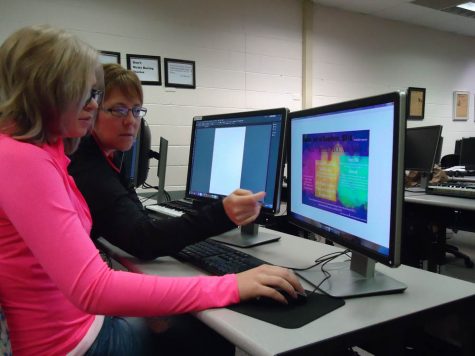 Instructor Bonnie Johnson-Bartee works with student Tana Buoy in the Editing and Publishing class