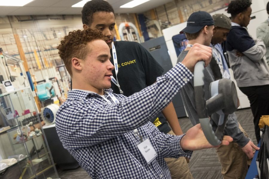 High school student Elijah Rosalez inspects a 3D printed steering wheel, commenting on how heavy it is. (Matt Weber/Minneapolis Star Tribune/TNS)