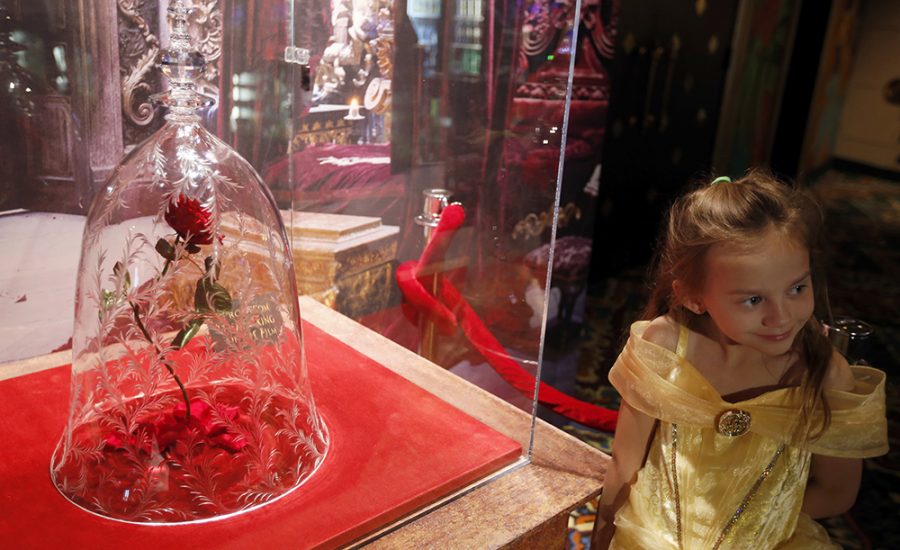 Rillie Duce, 6, poses with the rose in the lobby during the Beauty and the Beast Los Angeles premiere at the El Capitan Theatre March 16, 2017 in Hollywood, Calif.  (Francine Orr/Los Angeles Times/TNS)