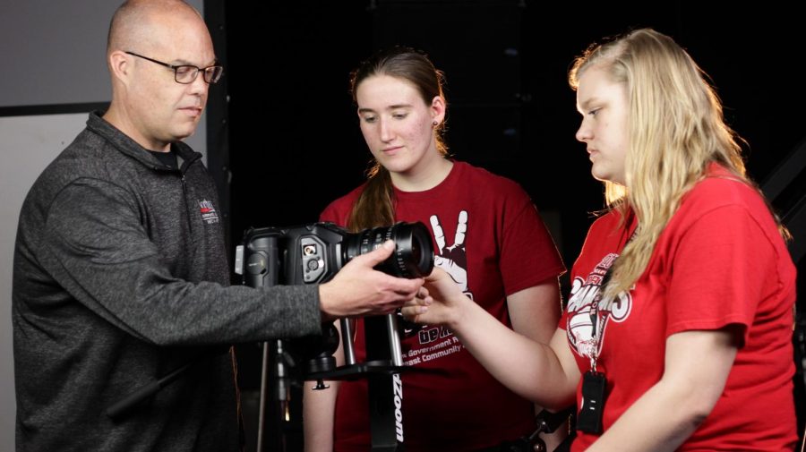 Brian Anderson, media arts - broadcasting instructor at Northeast Community College, explains camera and lens setting techniques to Emma Meisenheimer, Hartington, (center) and Madison Siedschlag, Pierce, students in the College’s Media Arts program. (Courtesy Northeast Community College) 