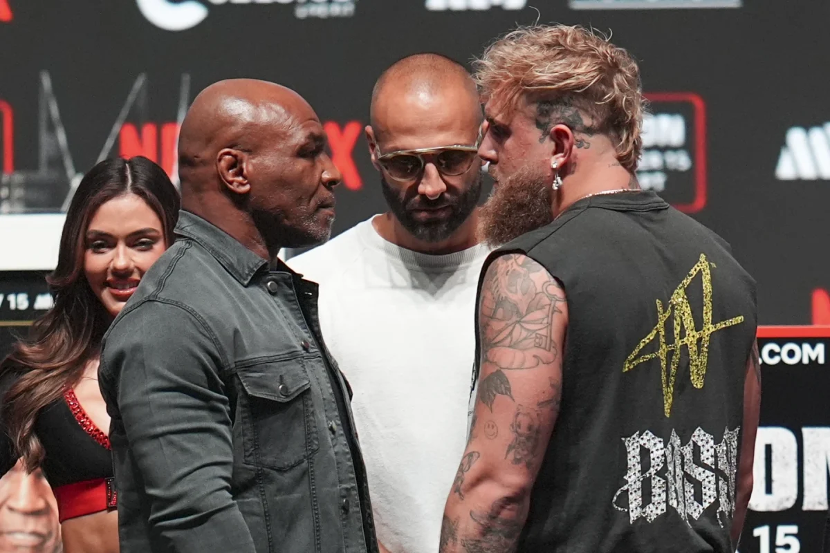 Mike Tyson, Front Left, and Jake Paul, Front Right, face off during a news conference ahead of their fight, Wednesday, Nov. 13 in Irving Texas. 